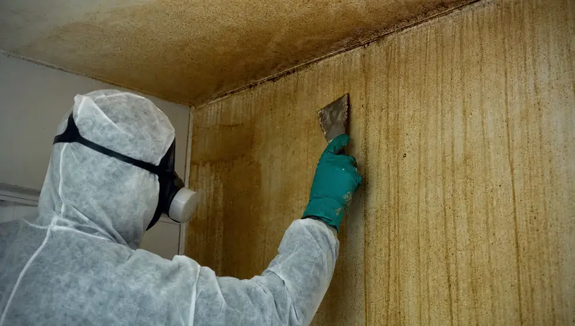 Close detail of heavy yellow-brown nicotine staining on a wall and ceiling.